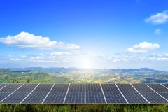 power solar panel on Forested Mountain blue sky background,alternative clean green energy concept
